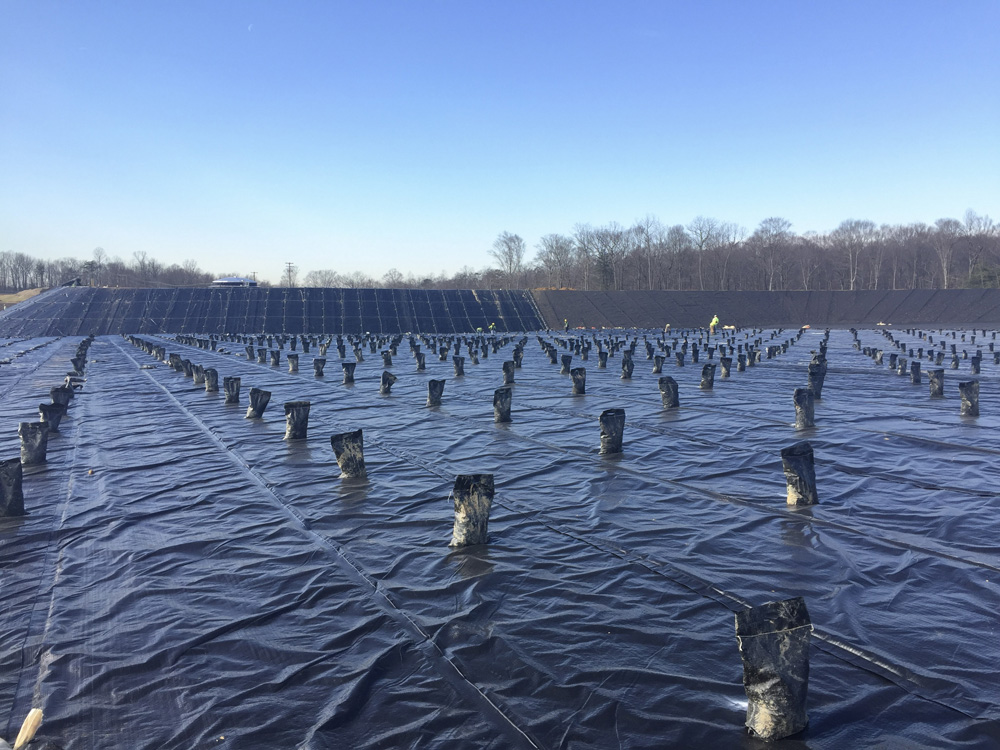 Methane gas control system with pipe boot penetrations protruding from HDPE geomembrane in a new landfill cell