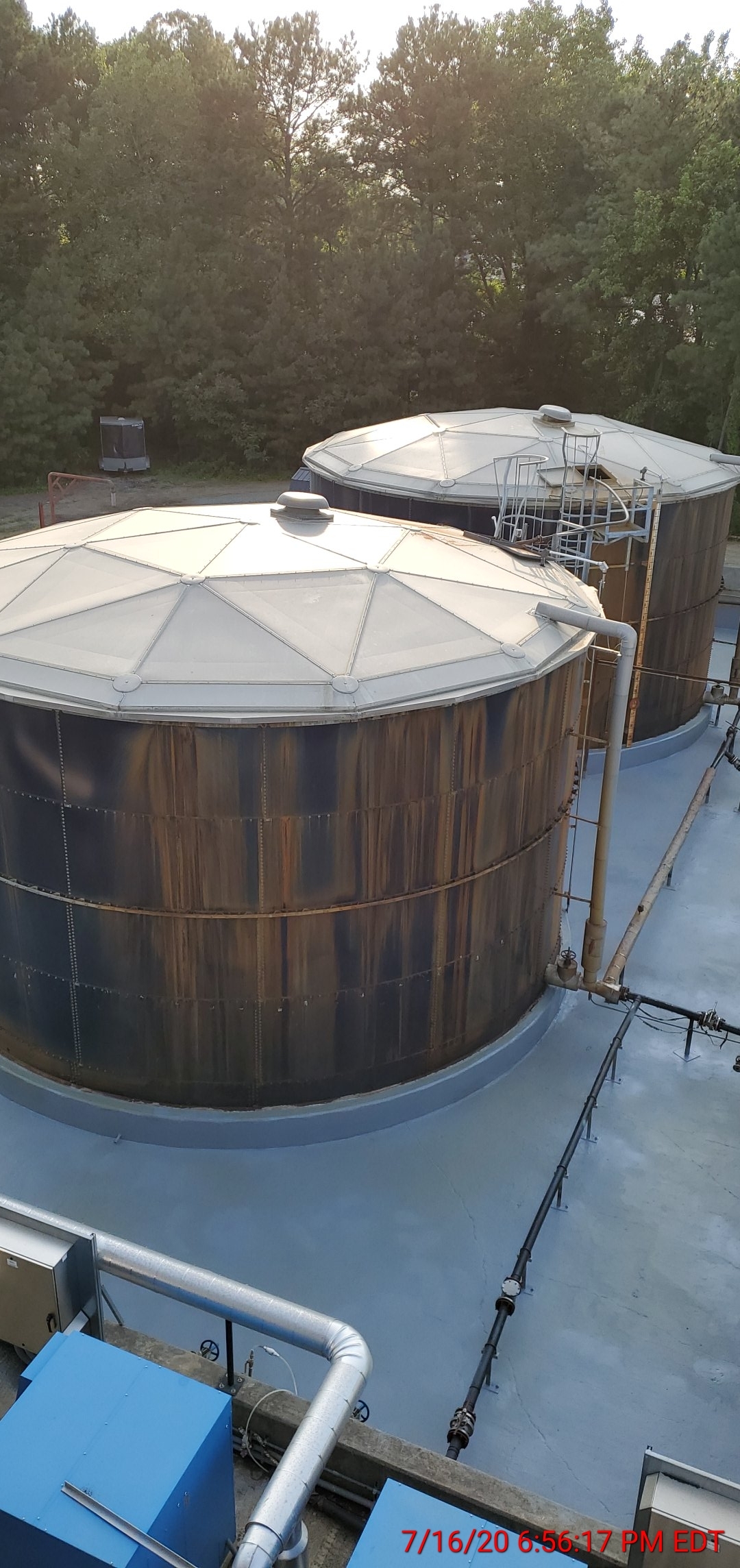 Side view of sulfuric acid tanks in the secondary containment area at Old Dominion Landfill after polyurea spray liner installation